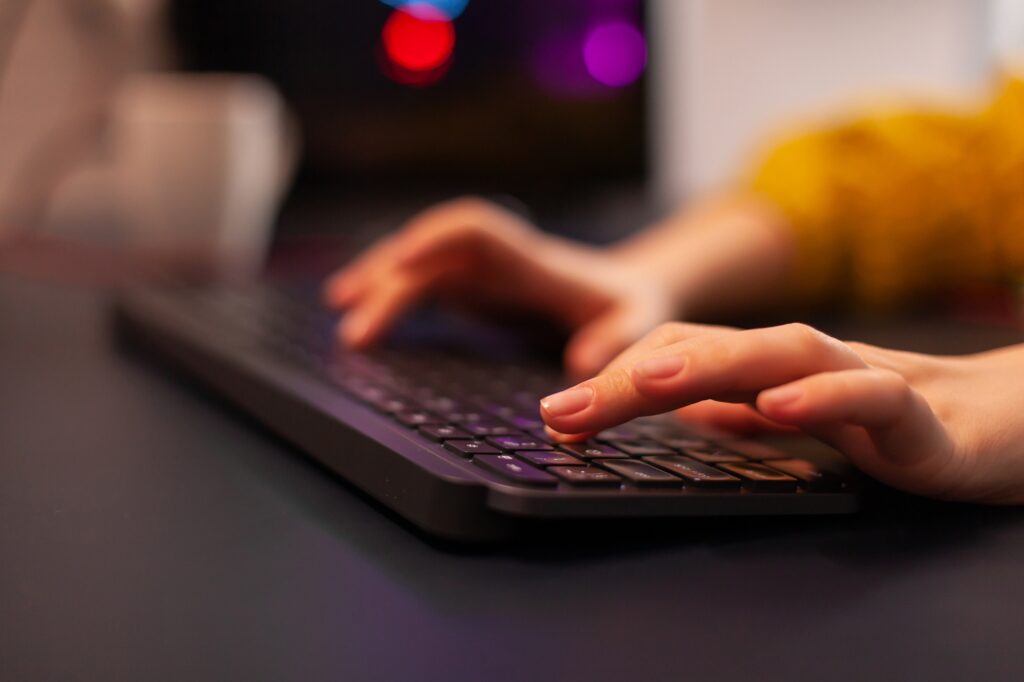 Close-up on hands of woman gamer playing video game