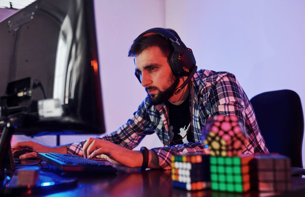 Portrait of young bearded pro gamer playing in online video game
